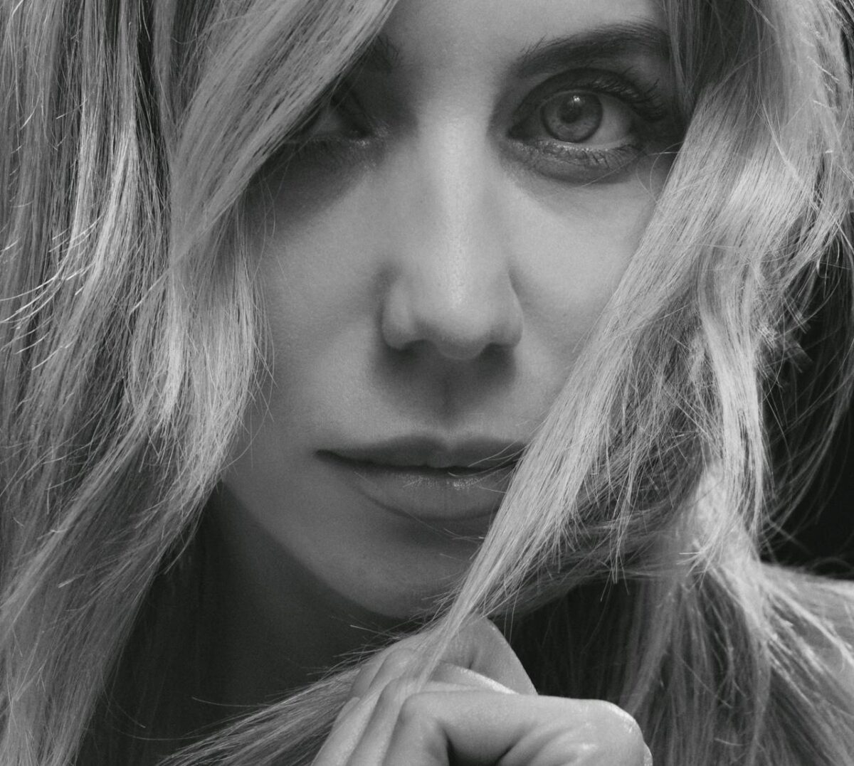 about-01 Close-up black and white portrait capturing a woman's expressive gaze.